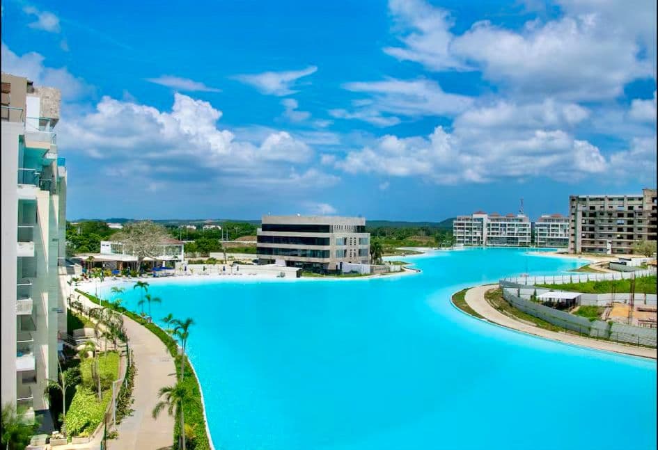 Elevated view of the turquoise crystal lagoon with palm walkways and the towers in Cartagena