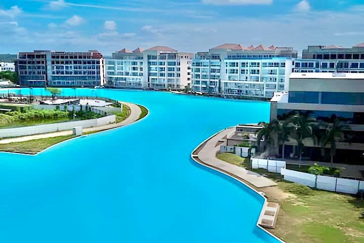 Real aerial photo of the turquoise crystal lagoon curving between the residential towers in Cartagena