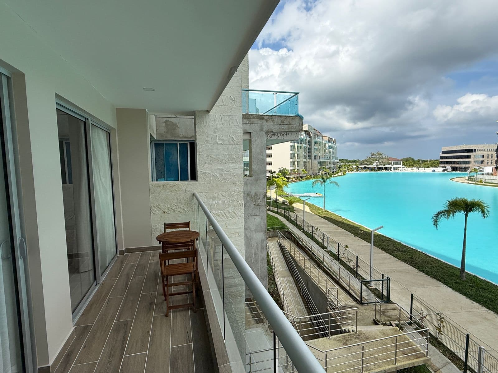 Private balcony with a bistro table looking out over the turquoise crystal lagoon